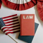 American flag with a law book, symbolizing independence and politics.