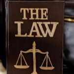 Detailed image of a book titled 'The Law' featuring scales of justice.