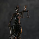 Elegant bronze Lady Justice statuette symbolizing law and justice.