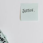 Sticky notes with messages on justice and rights on a flat surface.